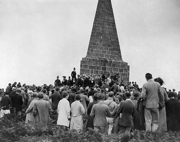 A crowd of people from nearby St Ives gather around the monument to John Knill former