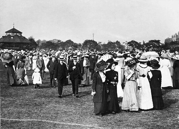 Crowd of people out for a walk in their Sunday Best at Birchfields Park in Rusholme