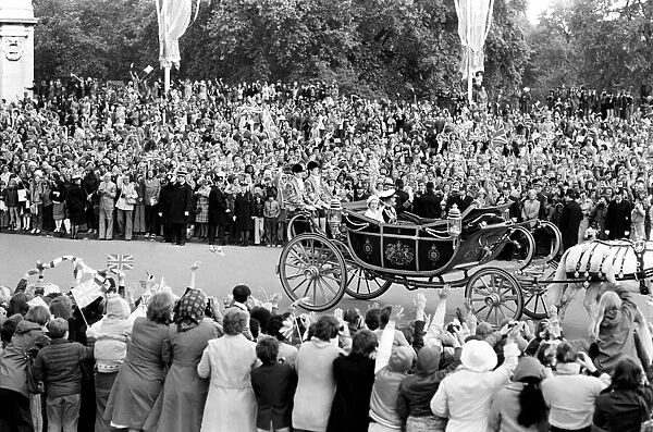 Crowd waving to the carriage of Queen Elizabeth II and Prince Philip
