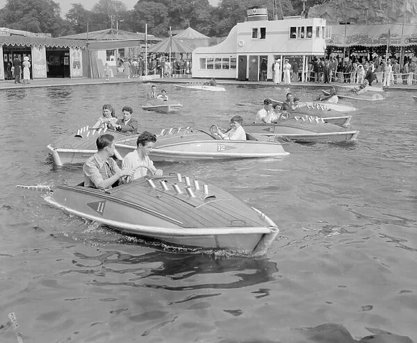 Crowds enjoying the small power boats on the boating lake at Battersea Pleasure Gardens