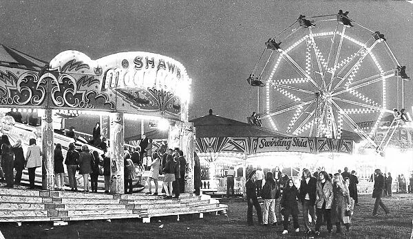The crowds at the Hoppings in 1971 are now thinning out as the evening starts drawing to