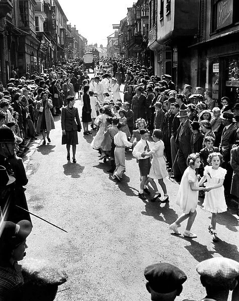 Crowds line the main street in Helston, Cornwall to watch the annual children