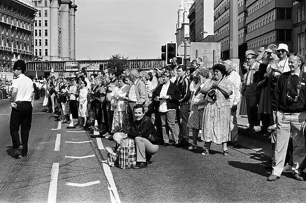 Crowds of people line the dock road set for a day out at Liverpool Albert Dock to see