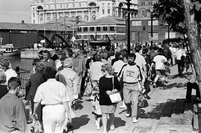Framed Print : Crowds of people line the dock road set for a day out at Liverpool Albert Dock to see Framed Print : Crowds of people line the dock road set for a day out at Liverpool Albert Dock to see