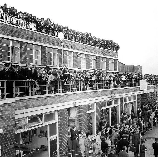 Crowds wait patiently for the The Beatles to arrive at Liverpool Airport for