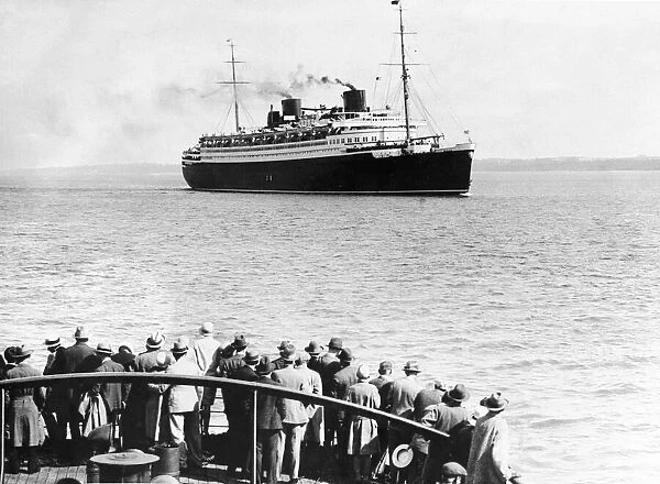 Crowds watch the ocean liner Bremen seen here in the Solent Circa 1936