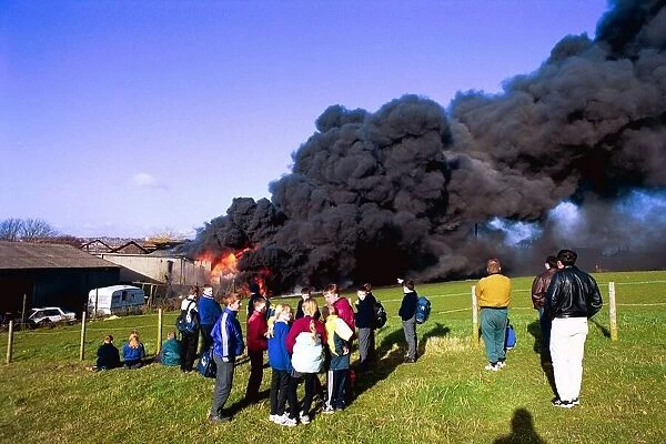 Crowds watch the smoke billow from a fire at Swalwell
