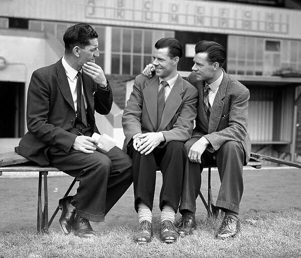 Crystal Palace manager Ronnie Rooke speaking to two players at a club meeting ahead of