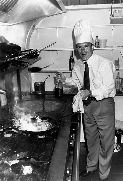 Crystal Palace manager Steve Coppell wearing chefs hat while cooking in the kitchen