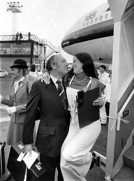 A cuddle for the cut-price king Freddie Laker from a Gatwick hostess
