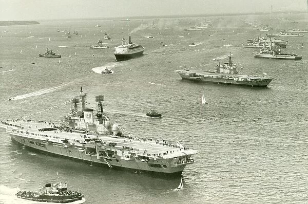 The Cunard liner QEII cruises through the fleet of Royal Navy ships gather at Spithead