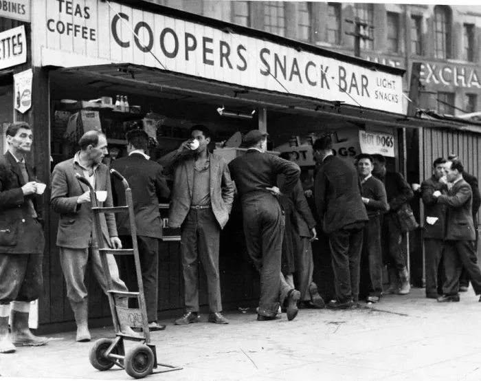 Framed Print : A cup of tea makes a welcome break for these men, many of whom have been working in