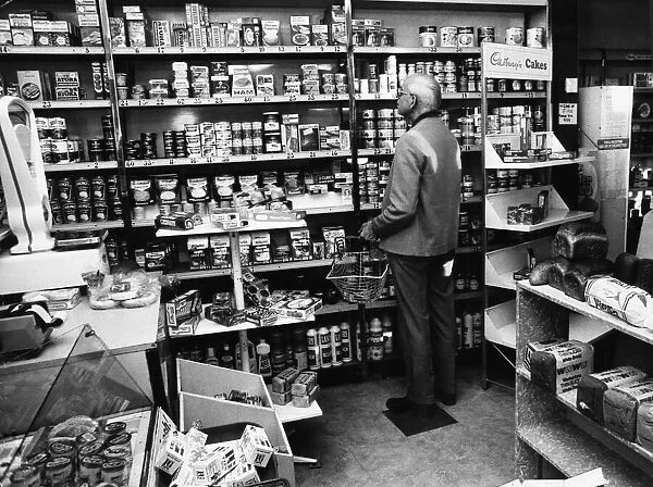 A customer eyes up the prices in local convenience store in Manchester