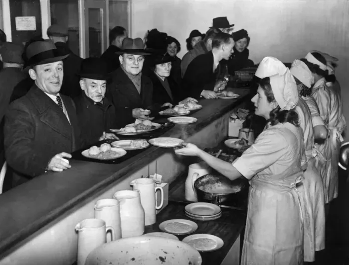 Framed Print : Customers filing past the serving counter at the communal feeding centre