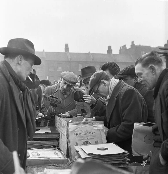 Customers at the secondhand gramophone record stall at the flea market in Club Row