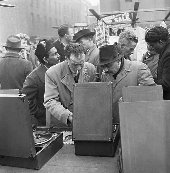 Customers at the secondhand gramophone stall at the flea market in Club Row