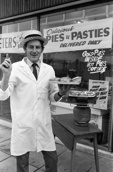 Framed Print : Customers waiting for their meat pies to warm up on the Calor gas cooker provided by Framed Print : Customers waiting for their meat pies to warm up on the Calor gas cooker provided by