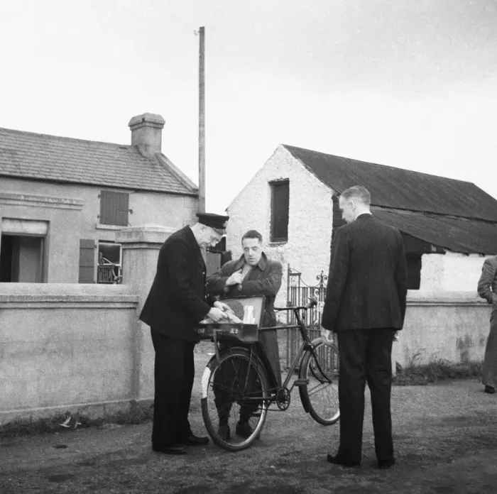 Framed Print : Customs officer checking the documents of a man on a bicycle at the Border Post between