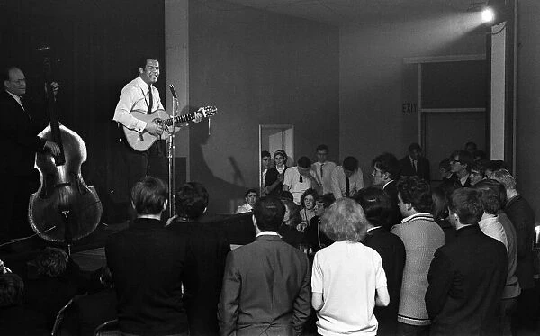 Cy Grant performs at a folk singing club in a Methodist Church, Kings Cross