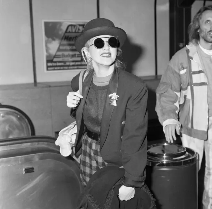 Framed Print : Cyndi Lauper american singer songwriter pictured with manager David Wolff arriving