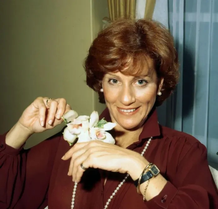 Framed Print : Cynthia Harris actress holding flower November 1978