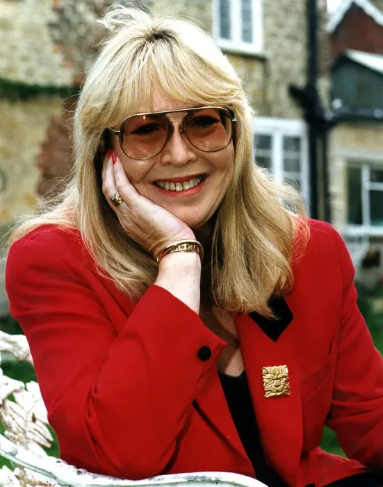 Framed Print : Cynthia Lennon wearing red jacket dark glasses December 1995