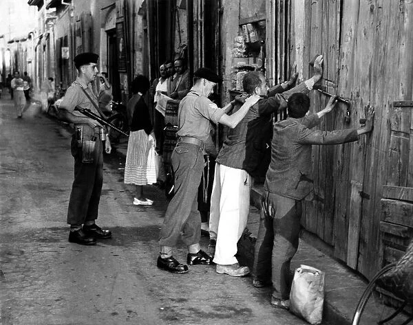 Cyprus War - British soldiers search Cypriots in a spot check in Nicosia