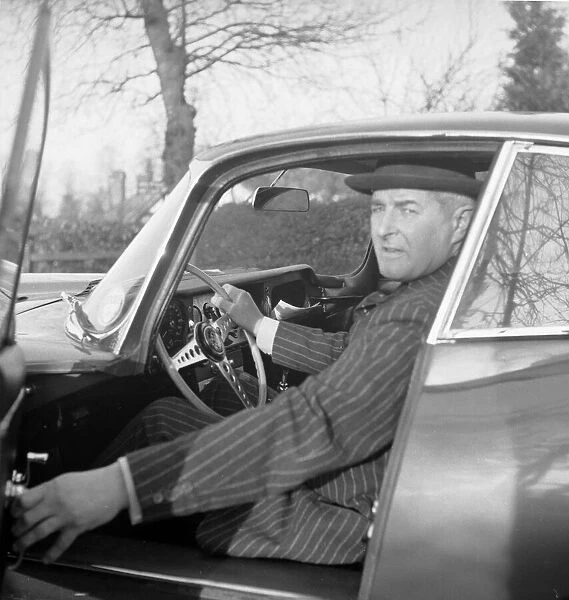 Daily Herald motor racing correspondent Thomas H Wisdom sitting at the wheel of a new