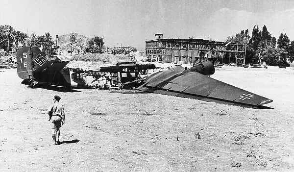 Damaged German aircraft at Comiso airfield in Sicily. 26th July 1943