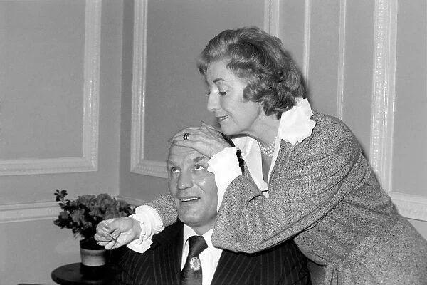 Dame Vera takes the temperature of her patient Henry Cooper. January 1976 76-00059-002