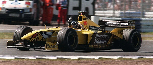 Damon Hill at the British Grand Prix July 1999 waves to the crowd at the end of the race