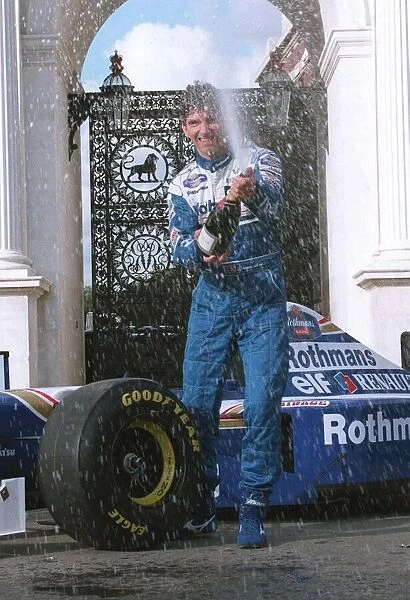 Damon Hill Motor Racing Formula One champion celebrates at Marble Arch with champagne