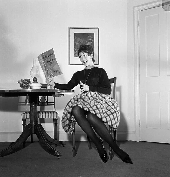 Dancer Una Stubbs, aged 22, in her flat in London. 4th December 1959