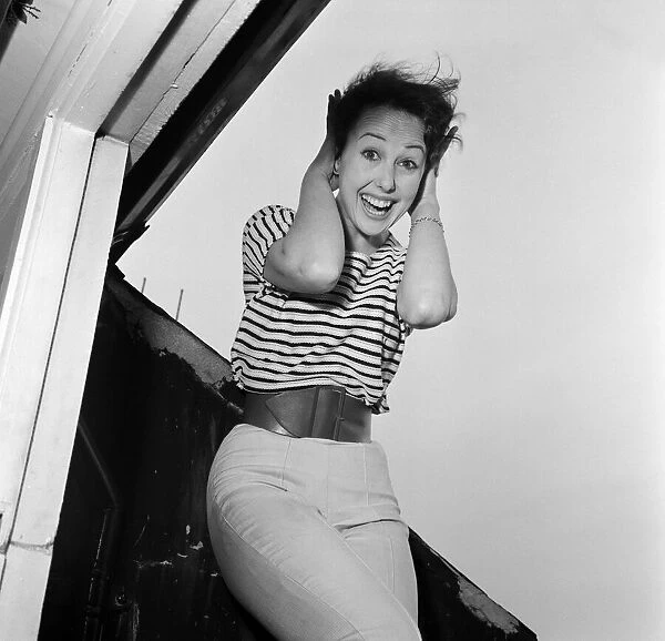 Dancer Una Stubbs, aged 22, in her flat in London. 4th December 1959