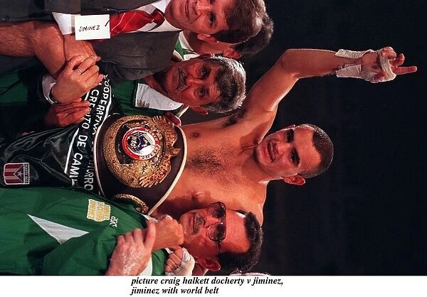 Daniel Jiminez with world belt and corner men trainers after holding on to WBO boxing
