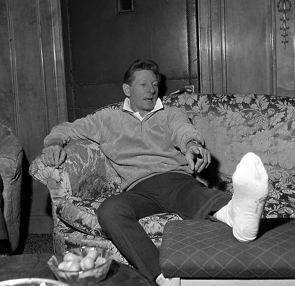 Danny Kaye at the Dorchester Hotel London nursing his badly burned foot He