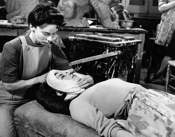 Framed Print : Daphne Lee arranges a protective cloth to save the plaster going on to the hair