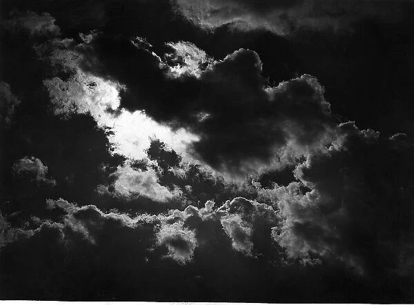 Dark rain clouds with the sun breaking through April 1947