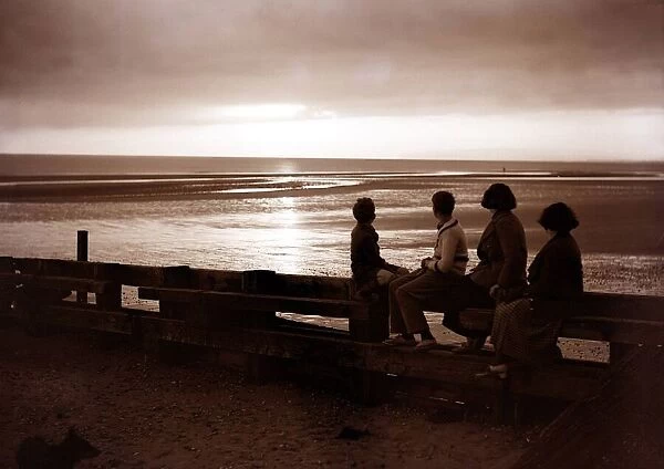Darkness falls around them as they watch the sunset at Rye Bay Sussex June 1935