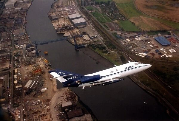 A Dassault Falcon 20 aircraft over the River Tees and the Transporter Bridge in