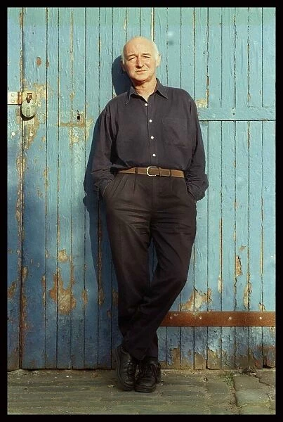 Dave Anderson actor stands at blue door June 1998 hands in pockets