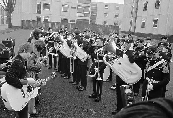 Dave Dee, Dozy, Beaky, Mick and Tich play a numbers while the regimental band of the 1st