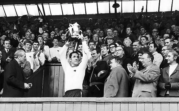 Dave Mackay holds aloft 2nd Divison Trophy after receiving the Championship Cup