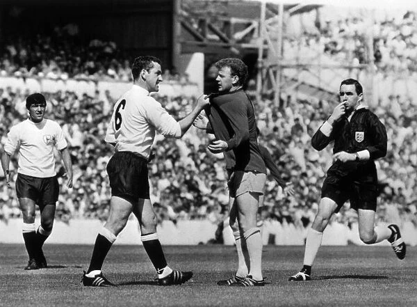 Dave Mackay of Tottenham Hotspur confronts Billy Bremner of Leeds during their First