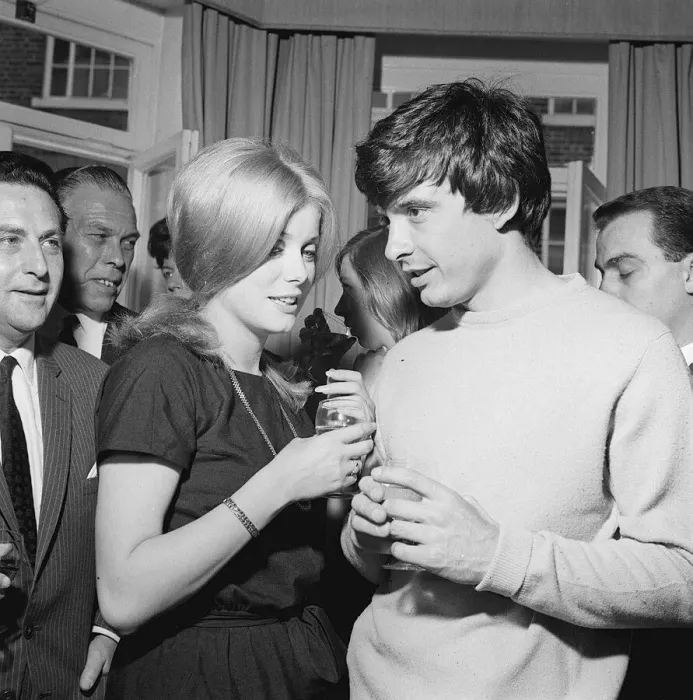 Framed Print : David Bailey and Catherine Deneuve have drinks with guests at a reception after their