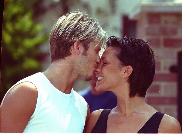 David Beckham and Victoria Adams Posh Spice kissing 1999 outside their home two days