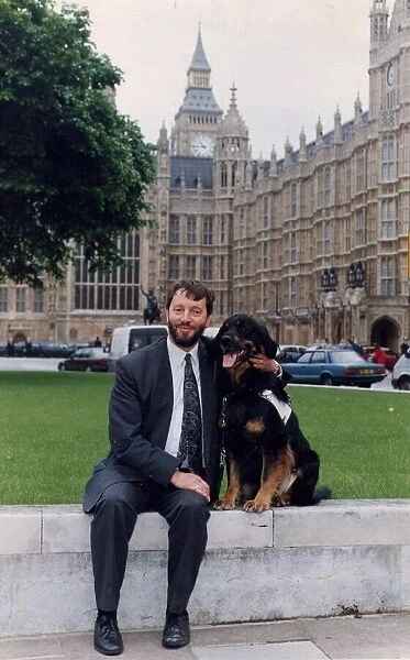 David Blunkett sitting outside Houses of Parliament with guide dog 26  /  05  /  1994