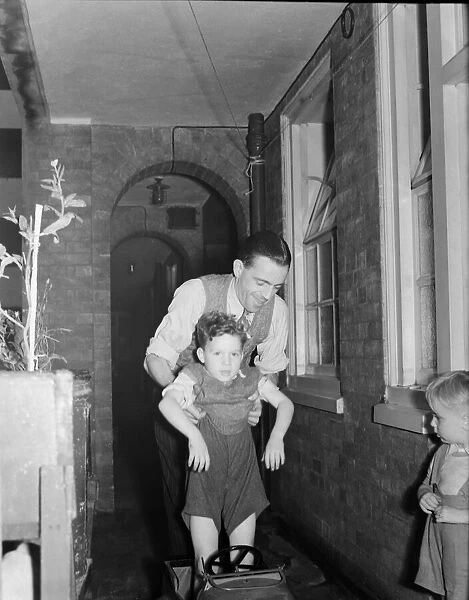 David Coles, whose wife is expecting quads with son David in London September 1950