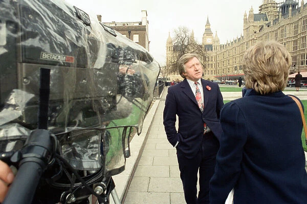 David Dimbleby, journalist and television presenter pictured during some outdoor filming