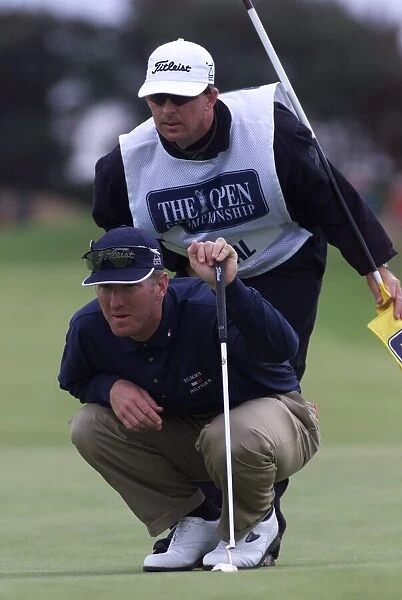 David Duval lines up a putt with his caddie July 1999 on the 11th green during